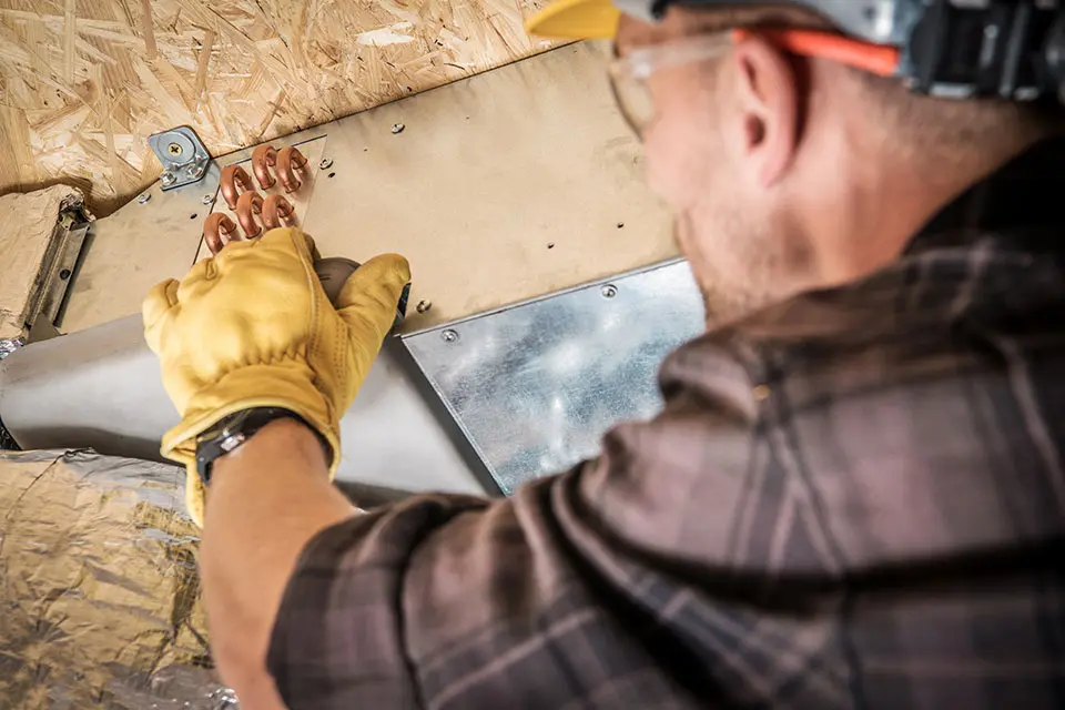 HVAC technician installing ductwork